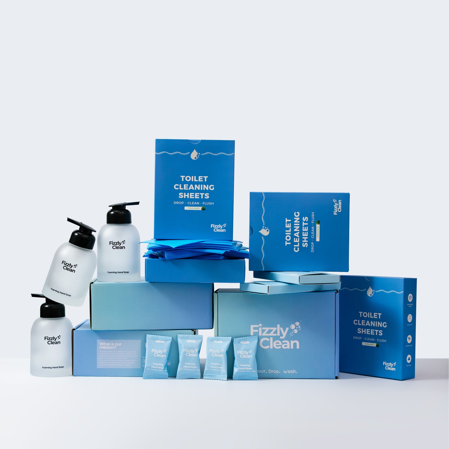 Fizzy Clean bathroom cleaning products including bottles, boxes, and cloths on a white background