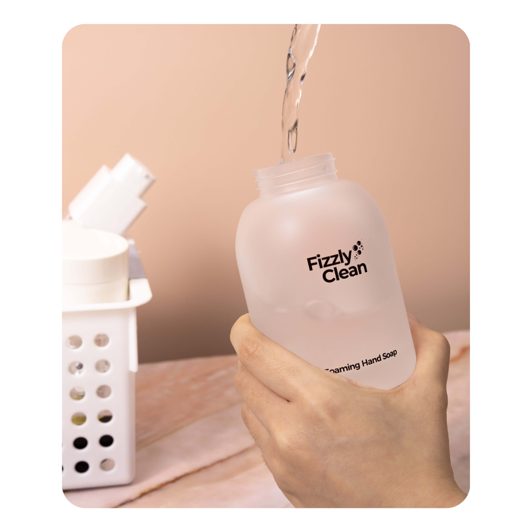 Hand holding a bottle labeled 'Fizzyly Clean'.