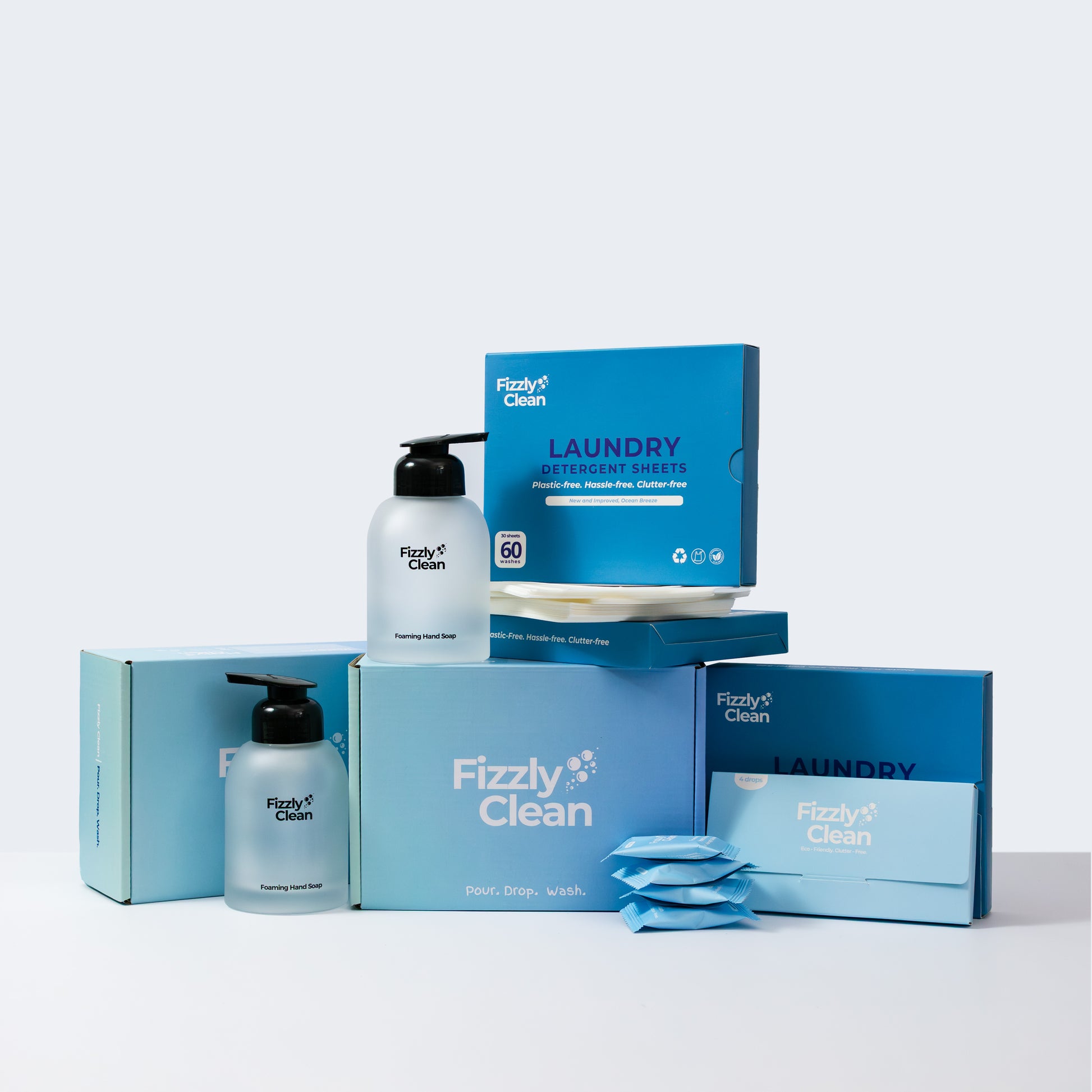 Fizzyly Clean laundry sheets including bottles and packaging on a light gray background